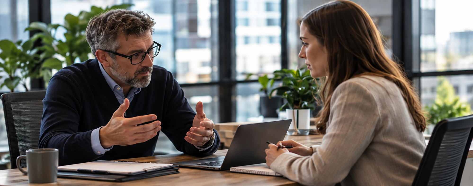 Colleagues discussing a proposal at a desk